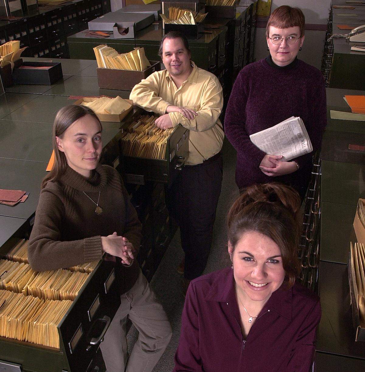 Members of The Star’s library staff pose next to file cabinets of newspaper clippings in 2002. Back row: Cliff Phillips and Janelle Hopkins. Front row: Laura Christensen and Johnna Flahive.