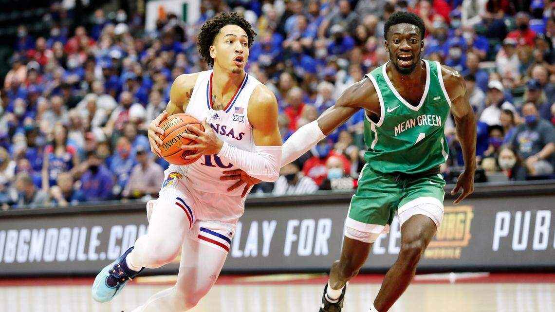 Kansas forward Jalen Wilson, left, drives to the basket in front of North Texas forward Thomas Bell during the first half of Thursday’s game in Florida.