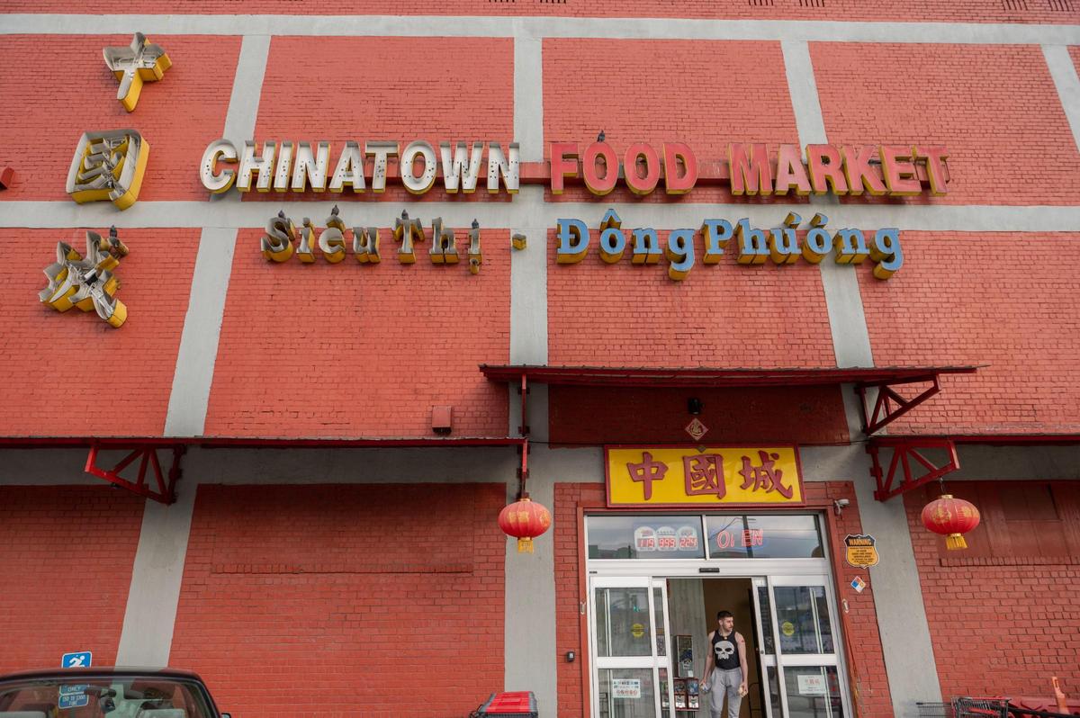 A shopper walks out of Chinatown Food Market on Thursday, Nov. 3, 2022 in River Market.