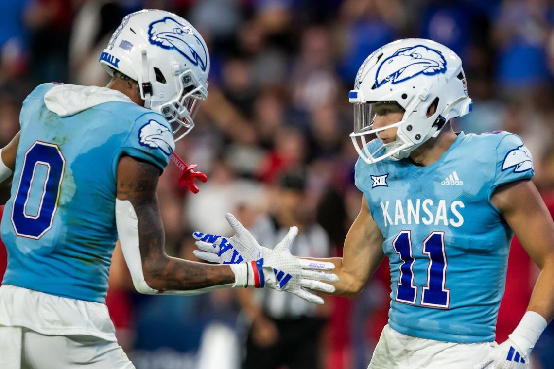Kansas wide receiver Luke Grimm (11) celebrates with wide receiver Quentin Skinner (0) after scoring a touchdown against the Lindenwood Lions on Thursday, August 29, 2024 at Children’s Mercy Park in Kansas City.
