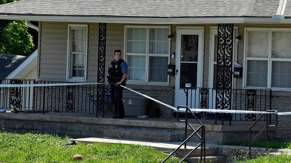 A Kansas City, Missouri police officer stands just outside the residence in the 4300 block of Linwood Blvd., where a homicide took place Sunday morning. Police said the victim was a female and that the investigation was ongoing. They did not have a suspect in custody.