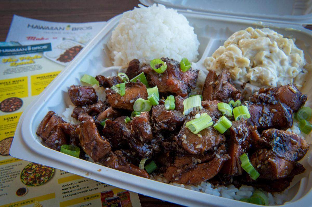 The Honolulu Chicken at Hawaiian Bros. is made with garlic, green onions and sesame and served with macaroni salad and white rice. The island-inspired chain serves traditional Hawaiian plate lunches, which feature meat and scoops of white rice and macaroni salad.