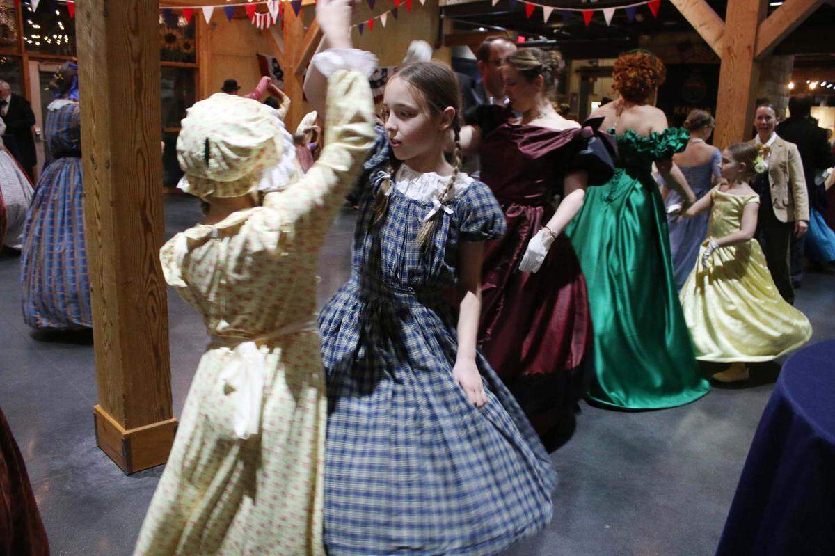 Olathe resident Abby Gregory, 9, dances with Leavenworth resident Fiona Baxter, 11, at the 1860s dance party at the Mahaffie Stagecoach Stop and Farm Jan. 27.