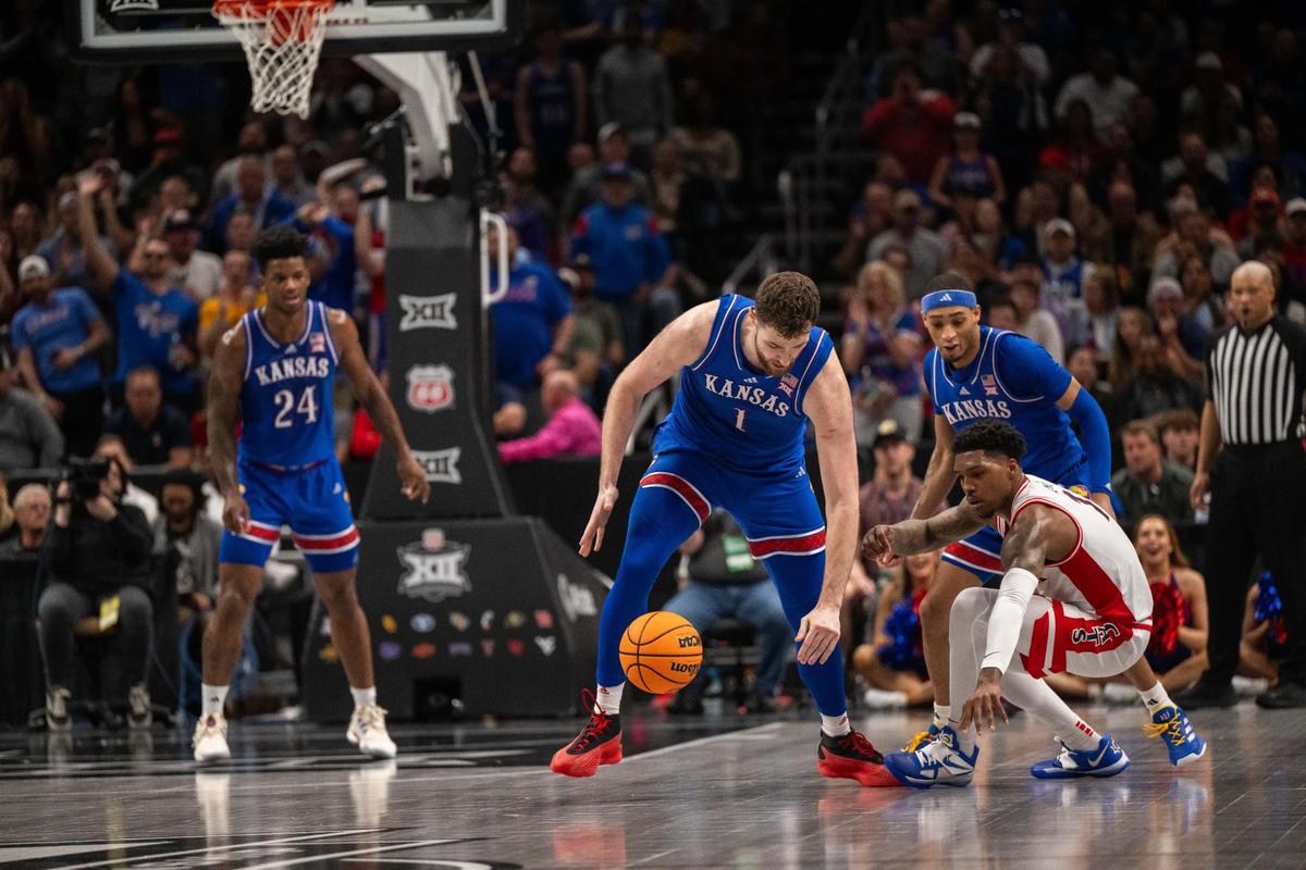 Kansas Jayhawks center Hunter Dickinson strips the ball from Arizona Wildcats guard Caleb Love in the first half of a Big 12 Championship quarterfinal game vs. the Arizona Wildcats on Thursday, March 13, 2025 at T-Mobile Center.