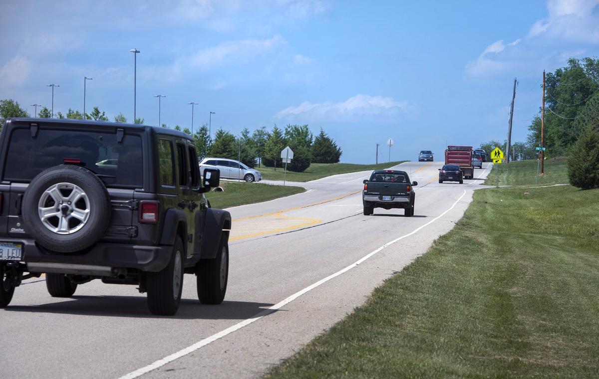 Vehicles travel north in the 17600 block of Quivira Road near Blue Valley Southwest High School in southern Overland Park. The city plans to improve the two-lane road, which has some nearby homeowners concerned about possible the impact to their property and trees.