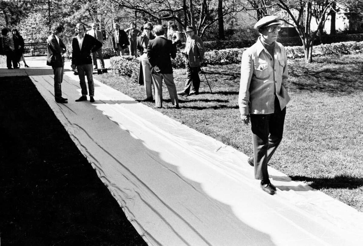 Visitors study Christo’s wrapped sidewalks at Loose Park.