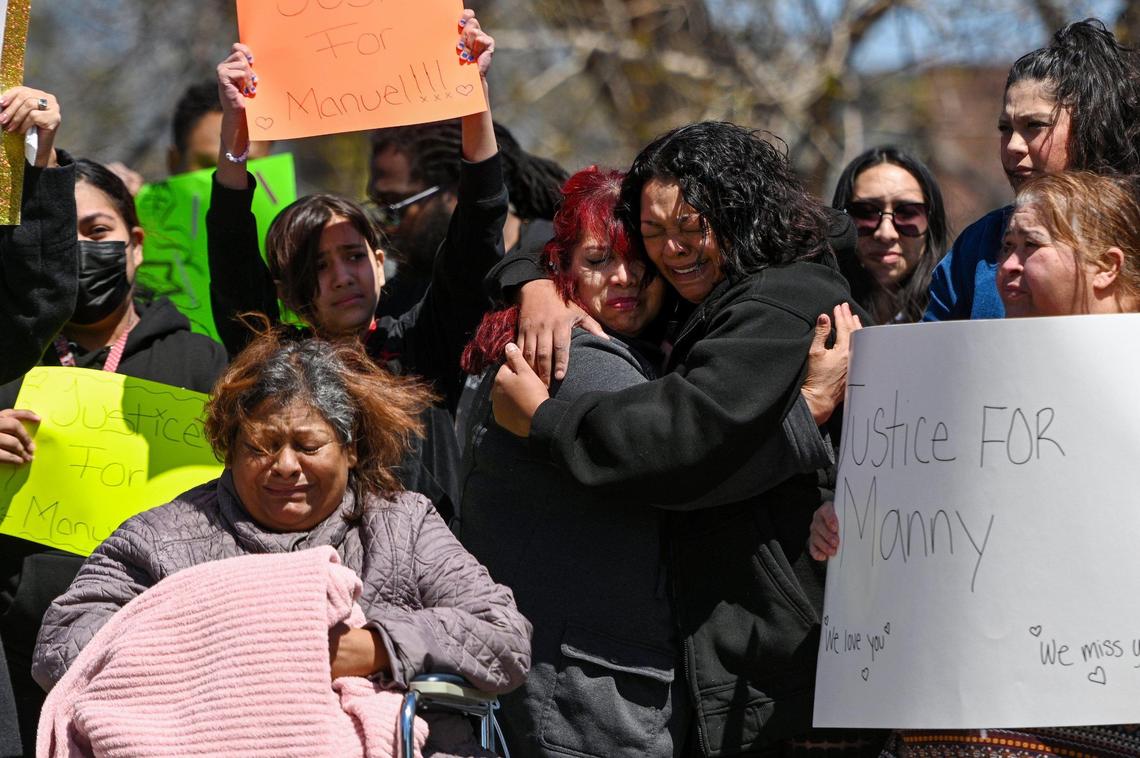 Vicenta Guzman, mother of Manuel Guzman, from right, hugs her friend Gabriela Garcia during a protest Monday as Manuel’s grandmother Maria Guzman, seated, reacts. Family and friends held a rally for justice for the 14-year-old Northeast Middle School student who was fatally stabbed April 12. At one point about 100 students joined them from behind barriers at the school at 4904 Independence Ave.
