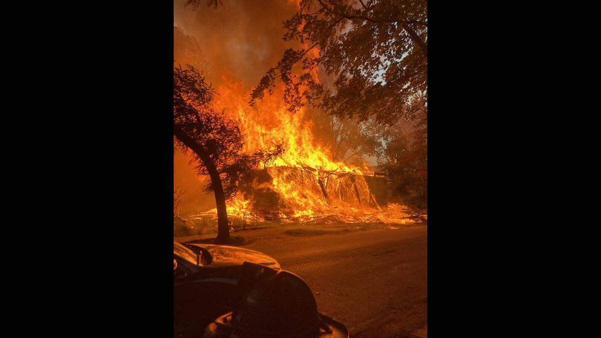 Investigators are looking into the cause of a two-alarm blaze that destroyed two houses under construction in the neighborhoods between Westport and the Country Club Plaza Sunday evening in Kansas City.