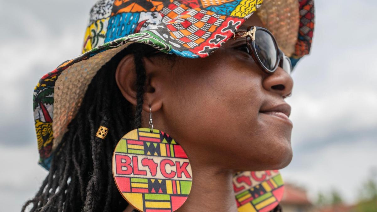 Sandra Thornhill showcases her Rastafari themed earring during the Juneteenth KC 12th annual Heritage Festival Saturday at the 18th and Vine district.