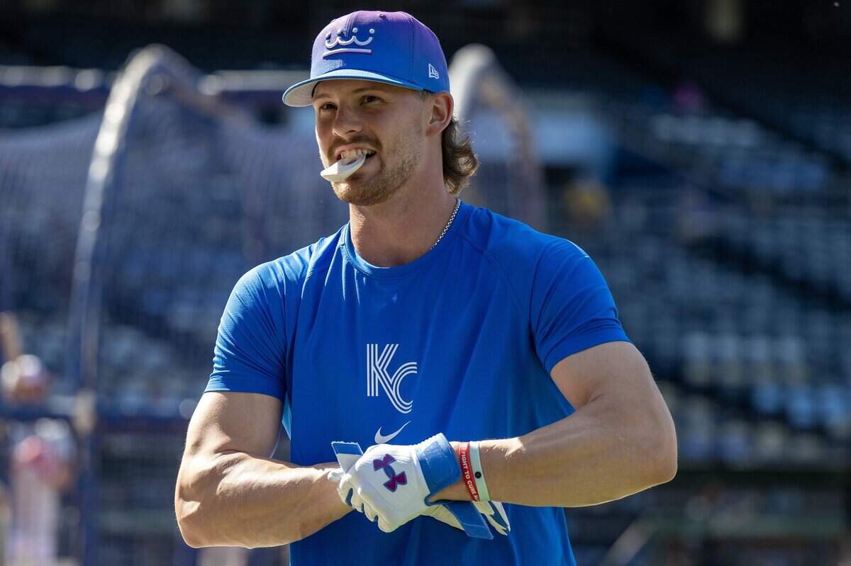 Kansas City Royals shortstop Bobby Witt Jr. (7) holds a batting accessory in his mouth during batting practice before a baseball game against the Houston Astros on Friday, June 12, 2026, at Kauffman Stadium in Kansas City.