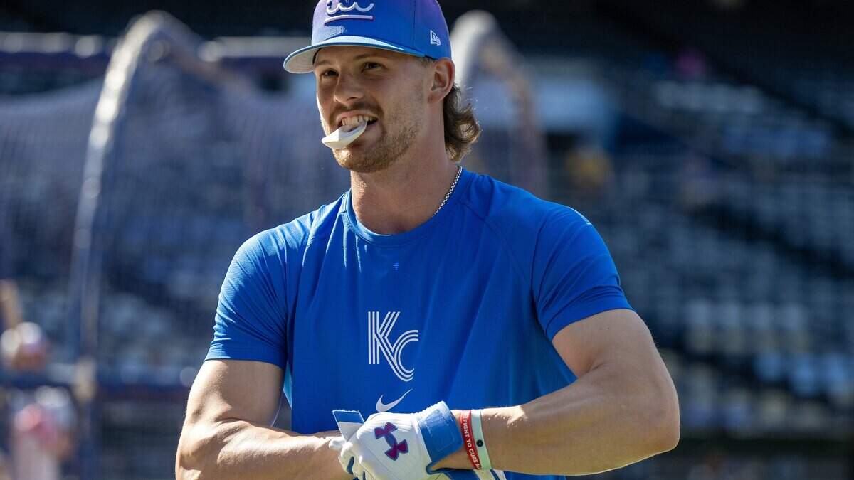 Kansas City Royals shortstop Bobby Witt Jr. (7) holds a batting accessory in his mouth during batting practice before a baseball game against the Houston Astros on Friday, June 12, 2026, at Kauffman Stadium in Kansas City.