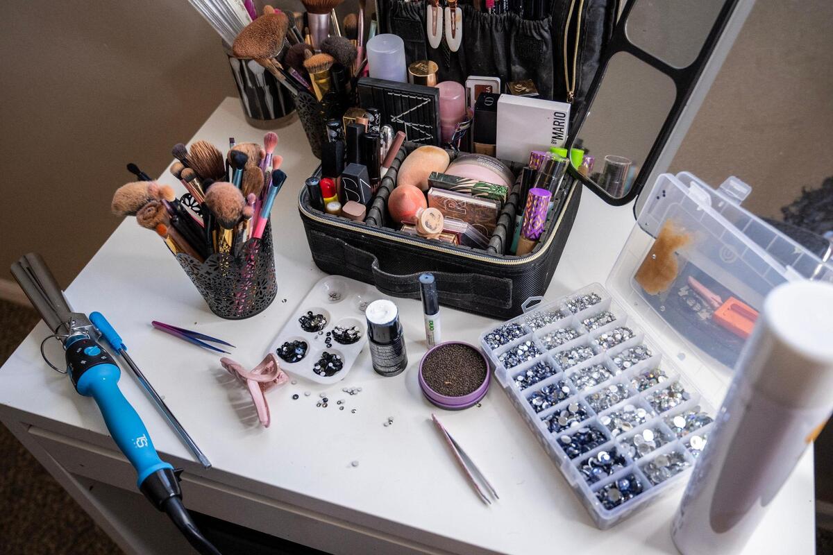 Makeup, jewels and hair products fill a table at Daniella Briones’ home as she prepares for the Dia de los Muertos festival at the Mattie Rhodes Center.