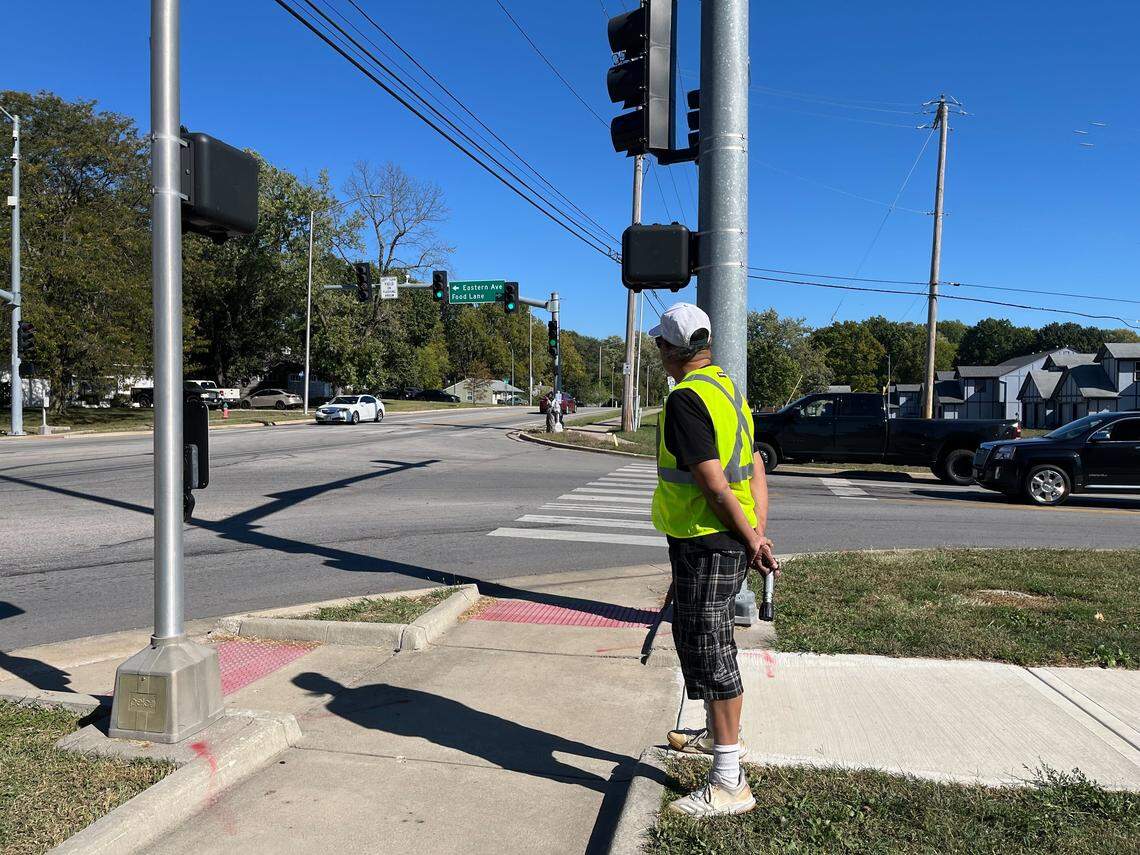 Jorge Delara watches a girl cross the intersection of Food Lane and Longview Road Thursday afternoon. He began volunteering as a crossing guard Thursday morning after a Ingels Elementary 3rd-grader was killed a few days before.