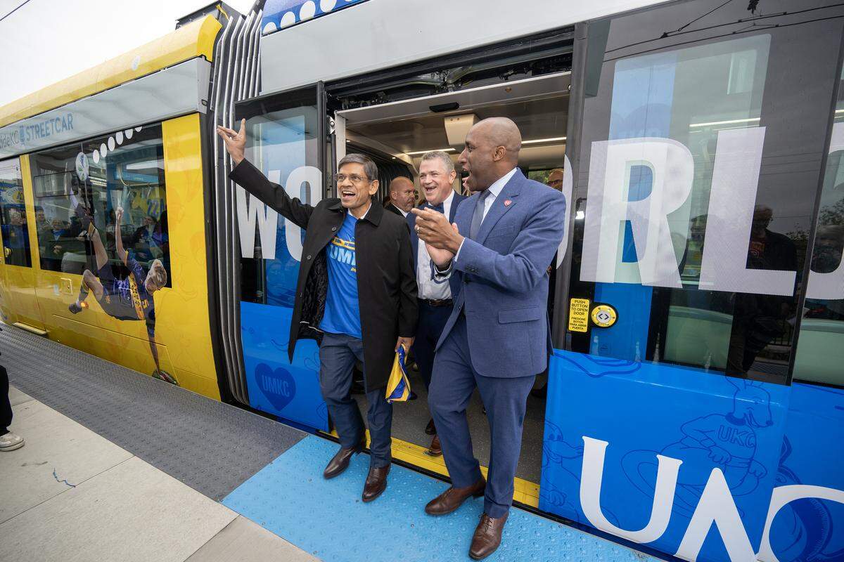 UMKC Chancellor C. Mauli Agrawal, left, Tom Gerend, executive director for KC Streetcar Authority, center, and Kansas City Mayor Quinton Lucas step off a streetcar after riding during an inaugural run on Friday, Oct. 24, 2025, during the grand opening celebration for the KC Streetcar extension in Kansas City. 