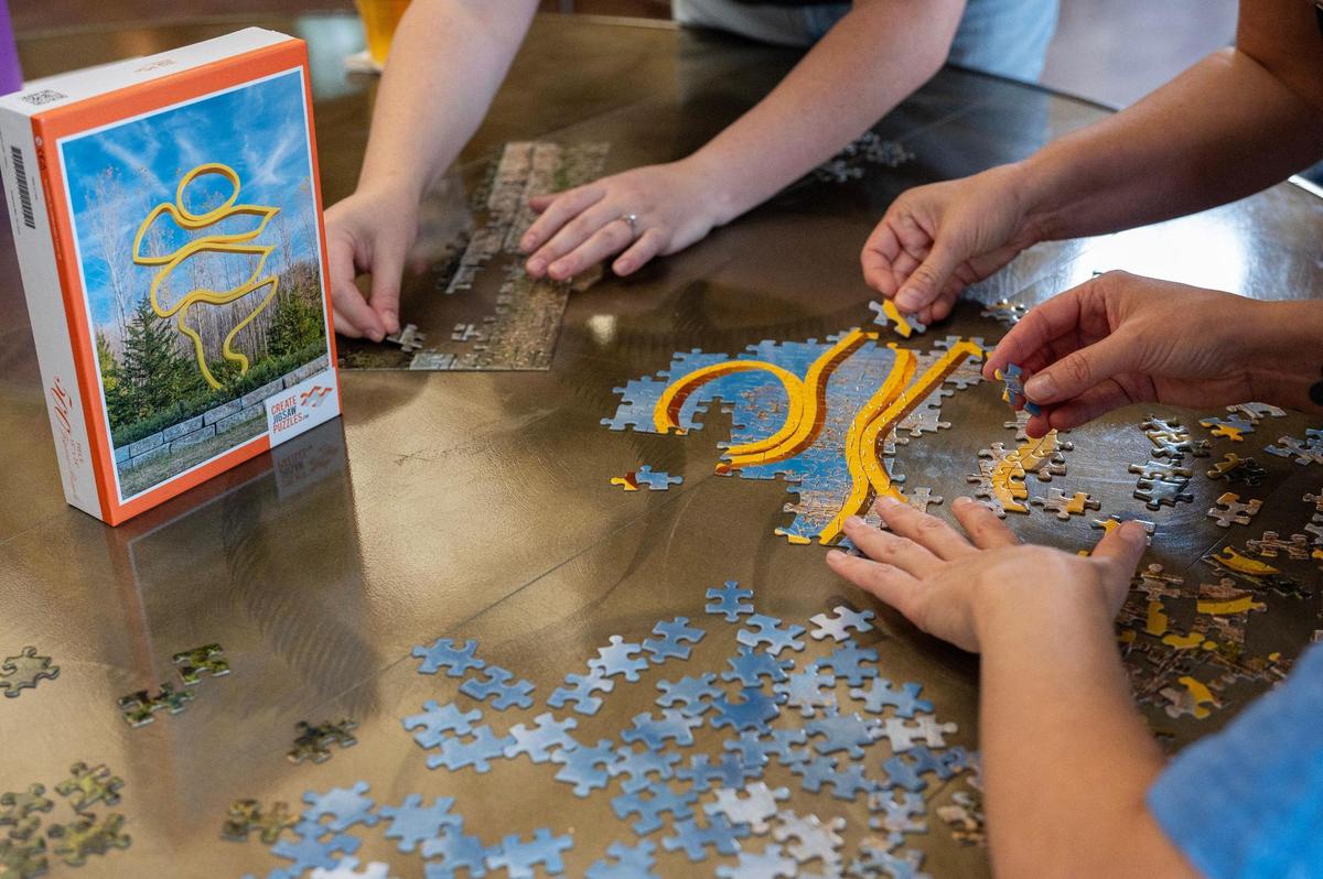 Wicker Kittens team members work together their puzzle during the Puzzle Palooza competition.
