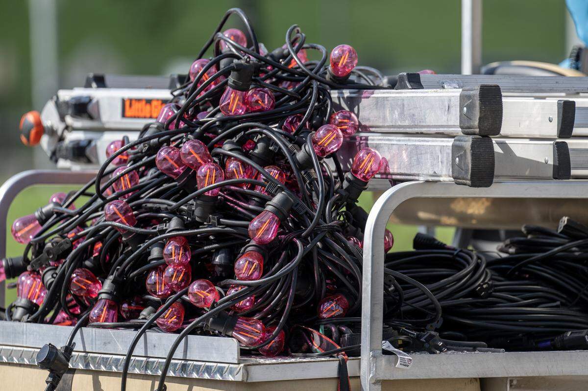 A pile of pink lights and other equipment is transported on a golf cart outside the National WWI Museum and Memorial on Wednesday, Oct. 1, 2025, in Kansas City, ahead of pop singer Chappell Roan's concert Visions of Damsels and Other Dangerous Things. 