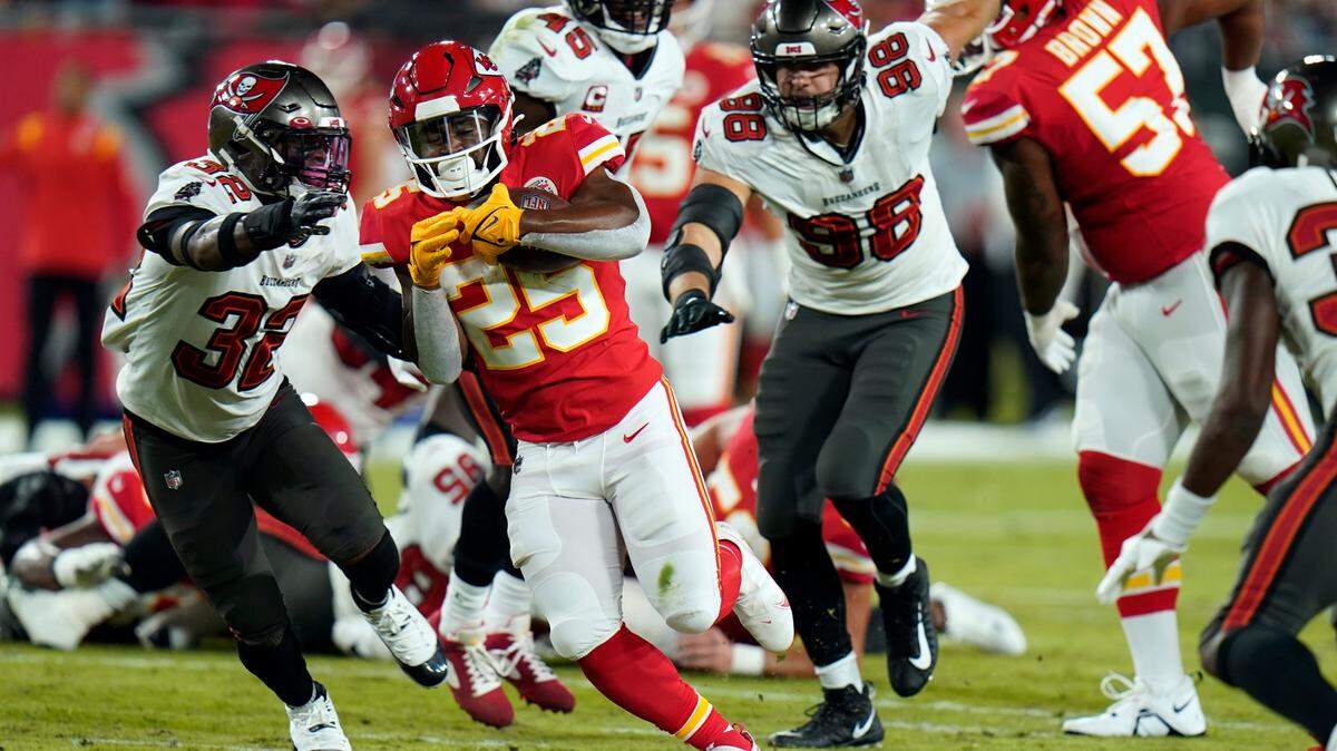 Kansas City Chiefs running back Clyde Edwards-Helaire (25) runs the ball as the offensive line blocks during the first half of an NFL football game against the Tampa Bay Buccaneers Sunday, Oct. 2, 2022, in Tampa, Florida.