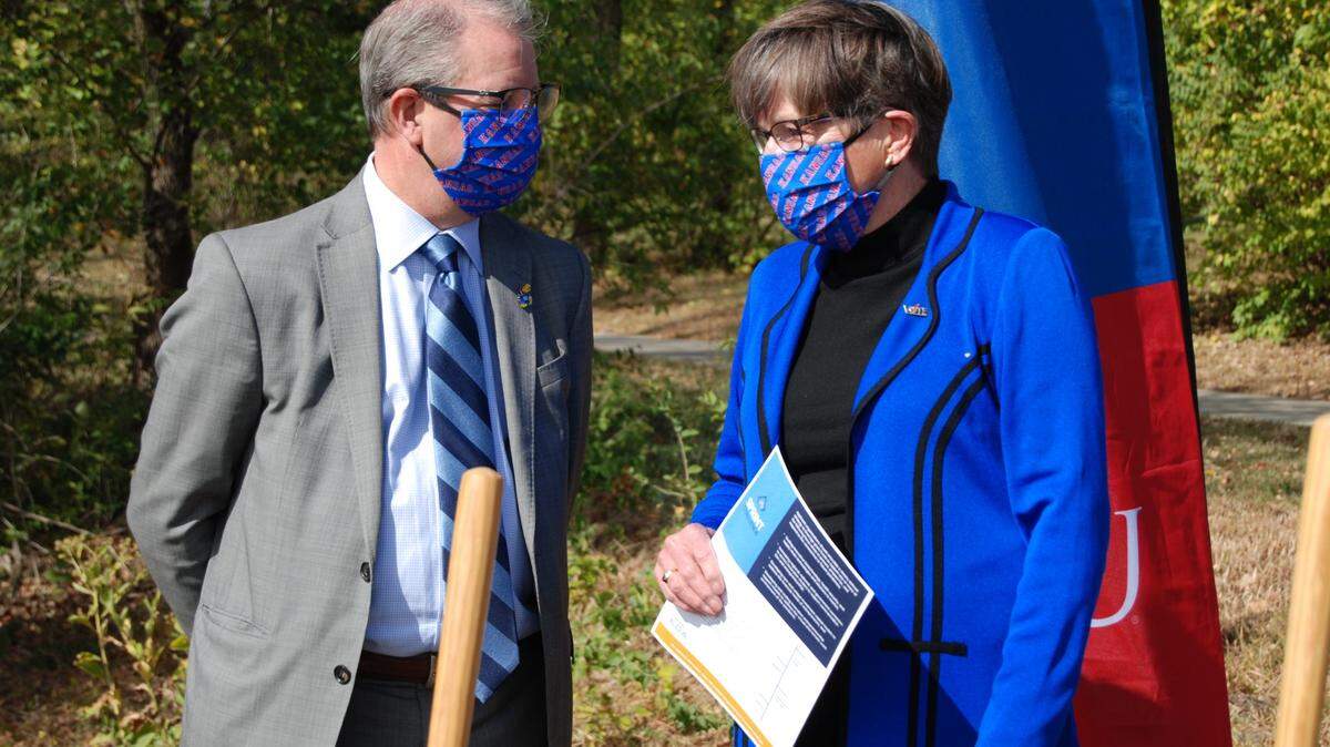 University of Kansas chancellor Doug Girod and Gov. Laura Kelly chat during a recent groundbreaking ceremony at the University of Kansas in Lawrence.