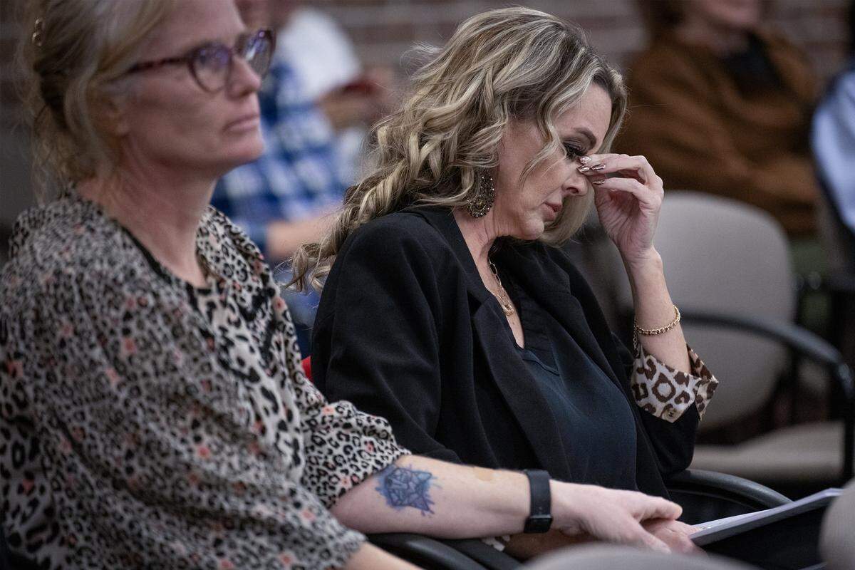 Stacey Anthuis of Drexel, Missouri, left, comforts Toni Skelton during a Prairie Village City Council meeting on Monday, Jan. 5, 2025. Surrounded by supporters, Skelton (second from right) listened to advocates speak on her behalf as officials debated a new exotic pet ordinance that will determine if she can keep her pet spider monkey.