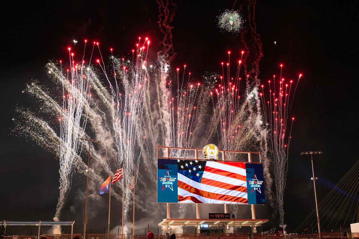 Fireworks from a Fourth of July show burst above CPKC Stadium, seen from behind the scoreboard looking toward the Missouri River, following the Maybelline Women’s Lacrosse League All-Star Game on Friday, July 4, 2025, in Kansas City.