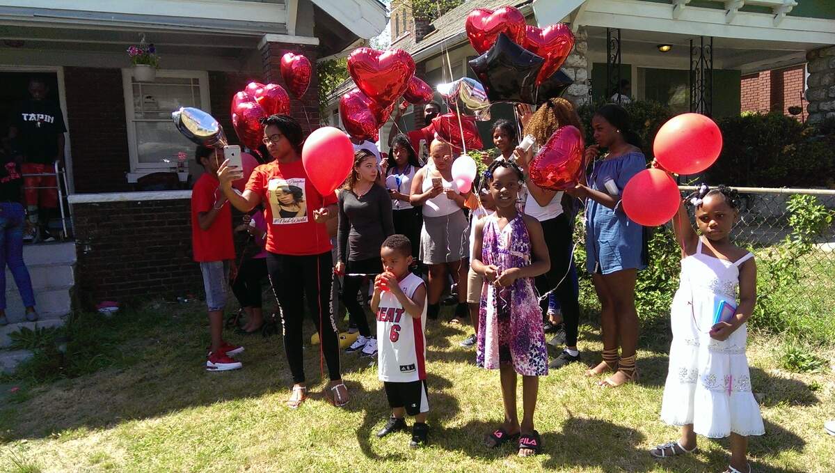 Family and the community of slain 18-year-old Vernece Brown gather Sunday at her Kansas City home where she was last seen Valentine's Day. Her remains were recently found in a wooded area in Cass County. Her killing remains unsolved.