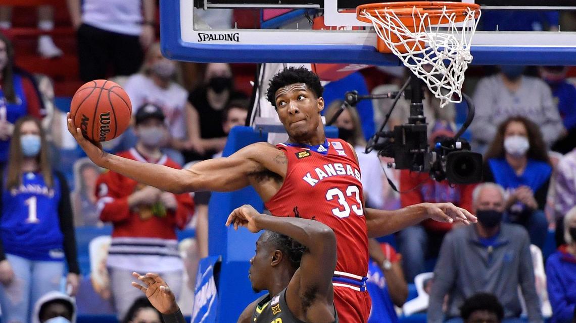 KU’s David McCormack makes an acrobatic catch over Baylor’s Jonathan Tchamwa Tchatchoua during the first half of Saturday night’s Big 12 Conference game at Allen Fieldhouse.