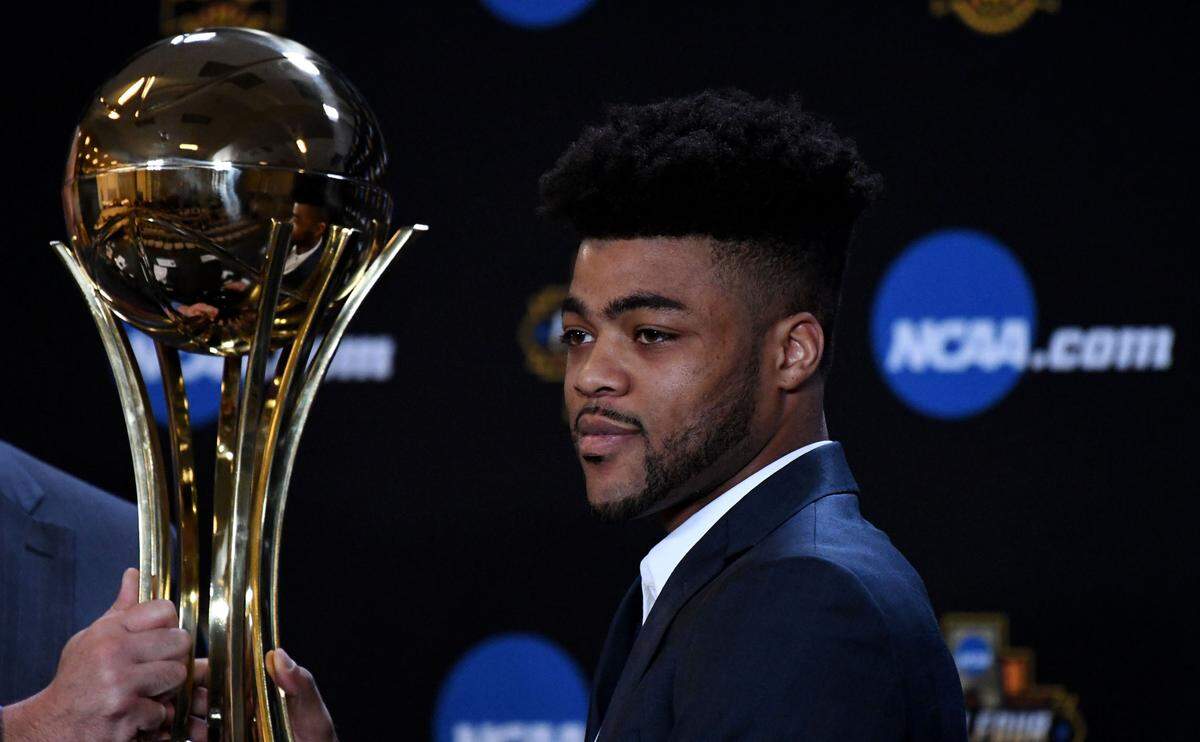 Kansas Jayhawks point guard Frank Mason III is presented with the AP Player of the Year trophy during a press conference at University of Phoenix Stadium Interview Room in Glendale, Arizona, on March 30, 2017.