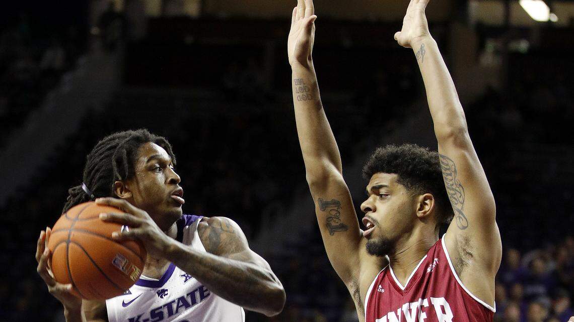 Kansas State’s Cartier Diarra (left) tried to pass the ball under pressure from Denver’s Jase Townsend during Monday night’s game in Manhattan, Kan. K-State won the game 64-56.