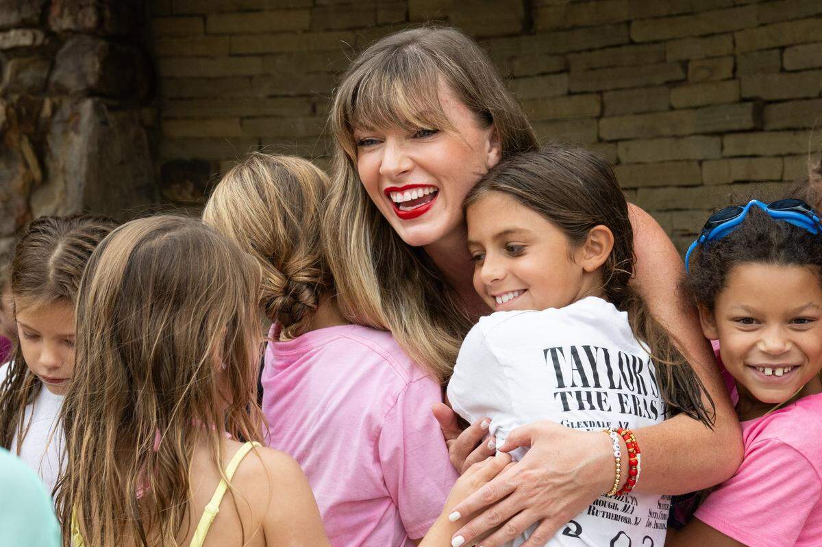 Kelley Thrasher of Johnson County hugged kids at a birthday party in Olathe last year.