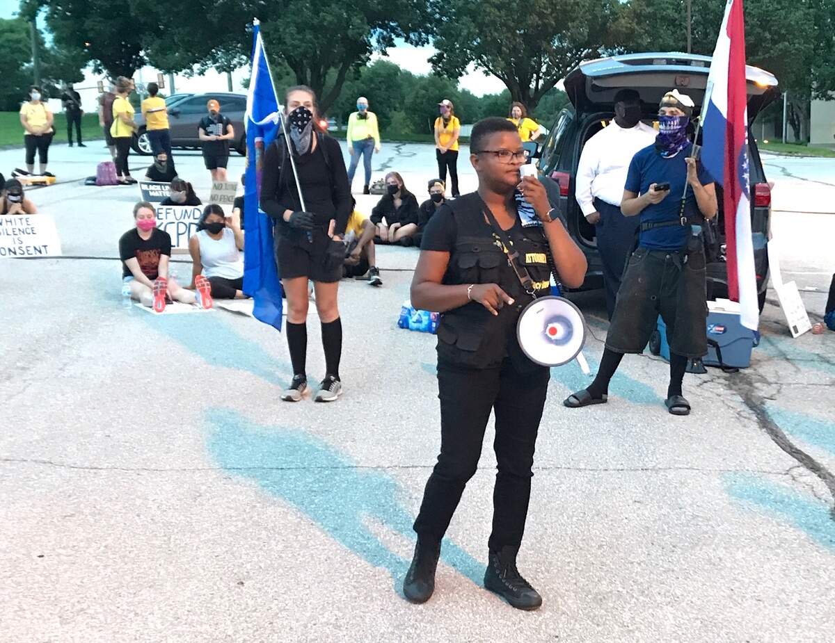 Attorney and activist Stacy Shaw addresses the crowd at a march that started in Prairie Village Saturday night.