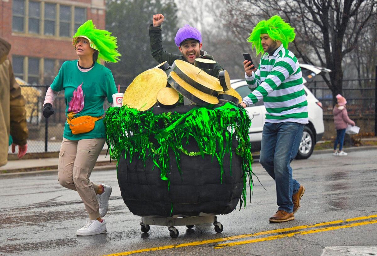 Parade participants from Livers Bronze Co., pushed an oversized pot of gold behind their float during the 2023 Brookside St. Patrick’s Day Warm-Up Parade on Saturday March 11, 2023 in Kansas City.