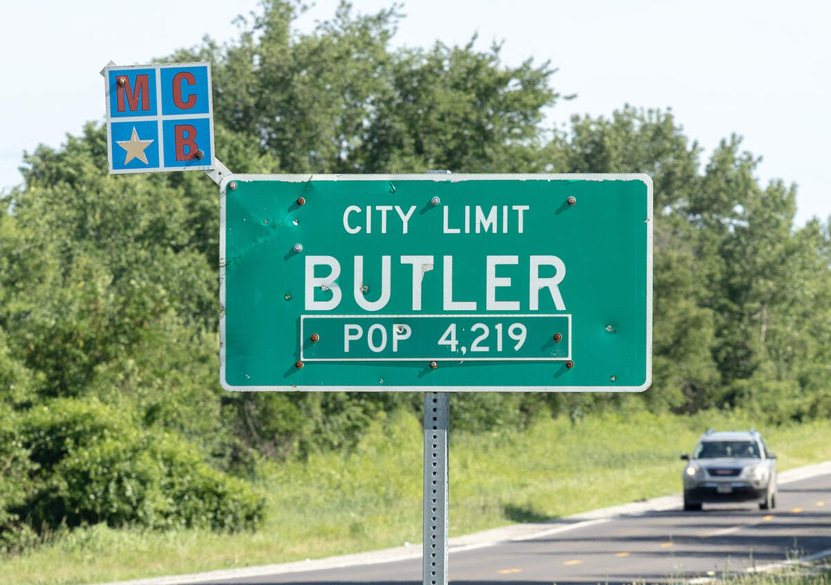 A sign at the edge of town in Butler, Missouri, where a plane crashed on Sunday, June 14, killing 12 people.