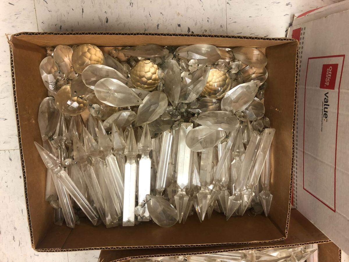 Pieces of the chandelier sit in boxes at the Glenwood Antique Mall.