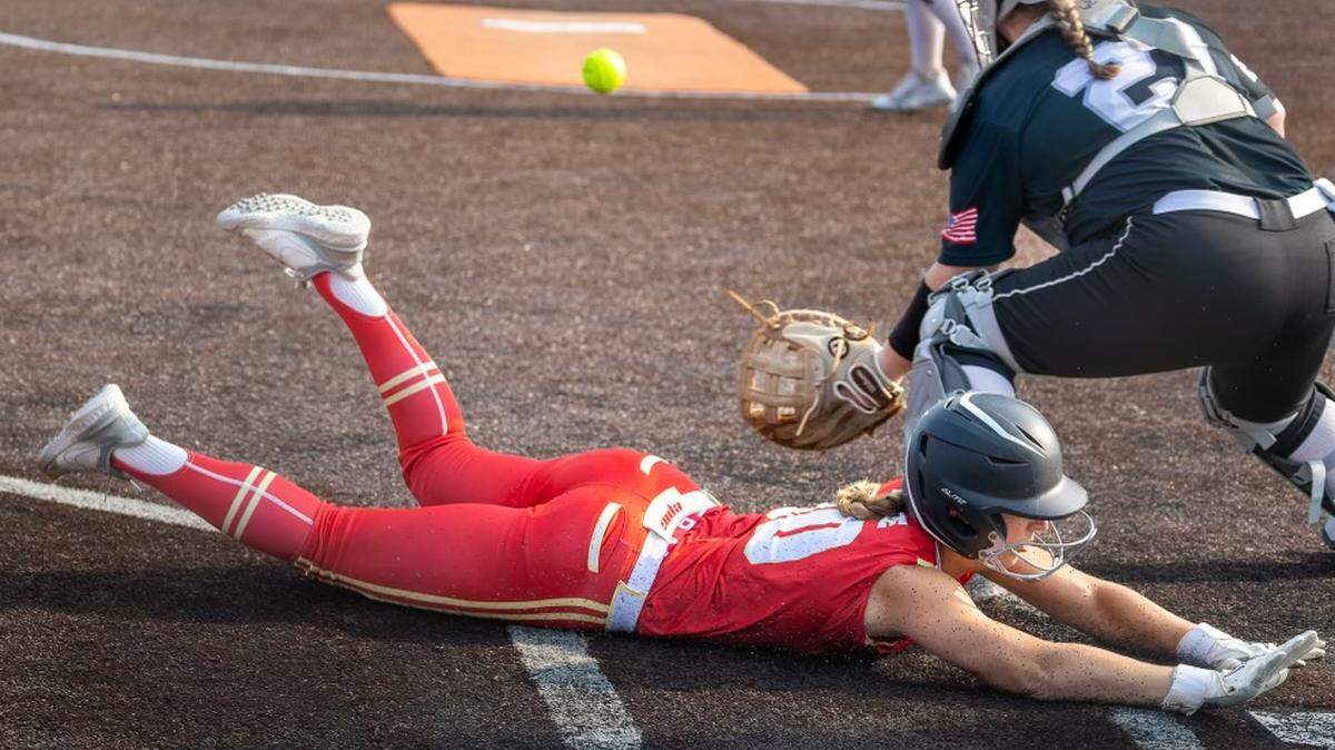 A player on the Epic National Lacina 18u team slides into home safely against So Cal Athletics Marinakas/Jaquish 24 National 18u during the KC-based 2023 Top Gun Invitational softball tournament.