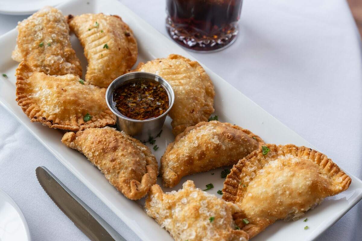 Various flavors of empanadas and Chimichurri sauce made from a family recipe at Piropos, on Tuesday, June 2, 2026, in Kansas City.