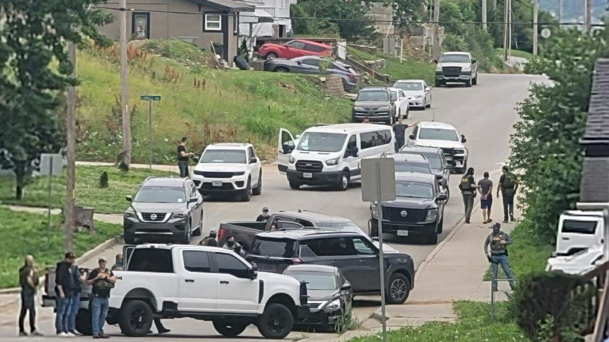 U.S. Homeland Security Investigations agents stand near 112 S. 16th St. in Kansas City, Kansas, following a morning arrest on May 28.