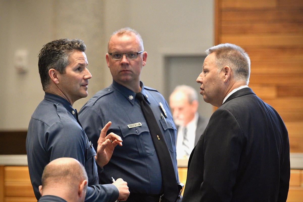 Chief Rick Smith, right, talks to police officers Tuesday, March 22, 2022, before the Board of Police Commissioners meeting.