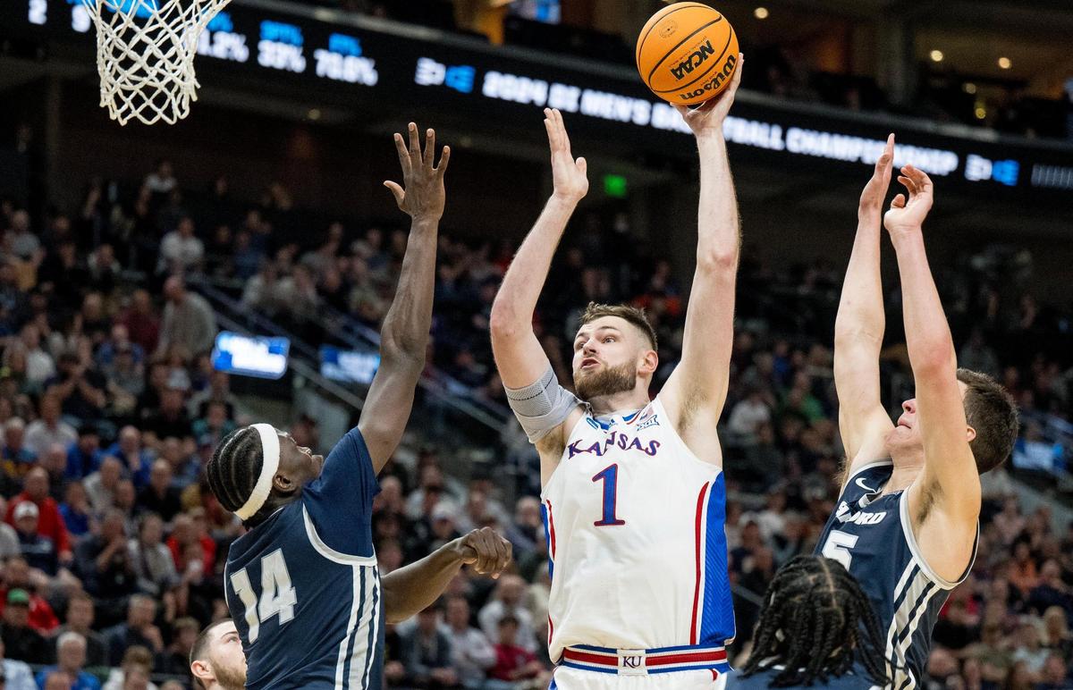 Kansas Jayhawks center Hunter Dickinson (1) shoots over Samford Bulldogs forward Achor Achor (14) during a men’s college basketball game in the first round of the NCAA Tournament on Thursday, March 21, 2024, in Salt Lake City, Utah.
