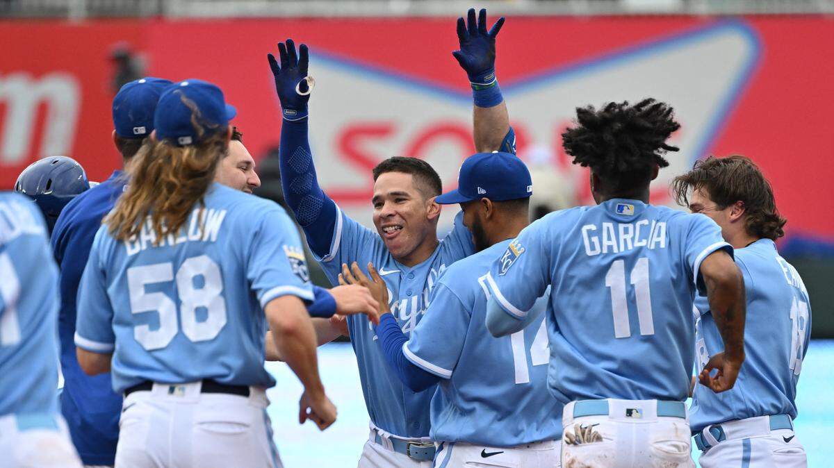 Kansas City Royals catcher Freddy Fermin (34) celebrates with teammates after driving in the winning run against the White Sox at Kauffman Stadium on May 11, 2023.