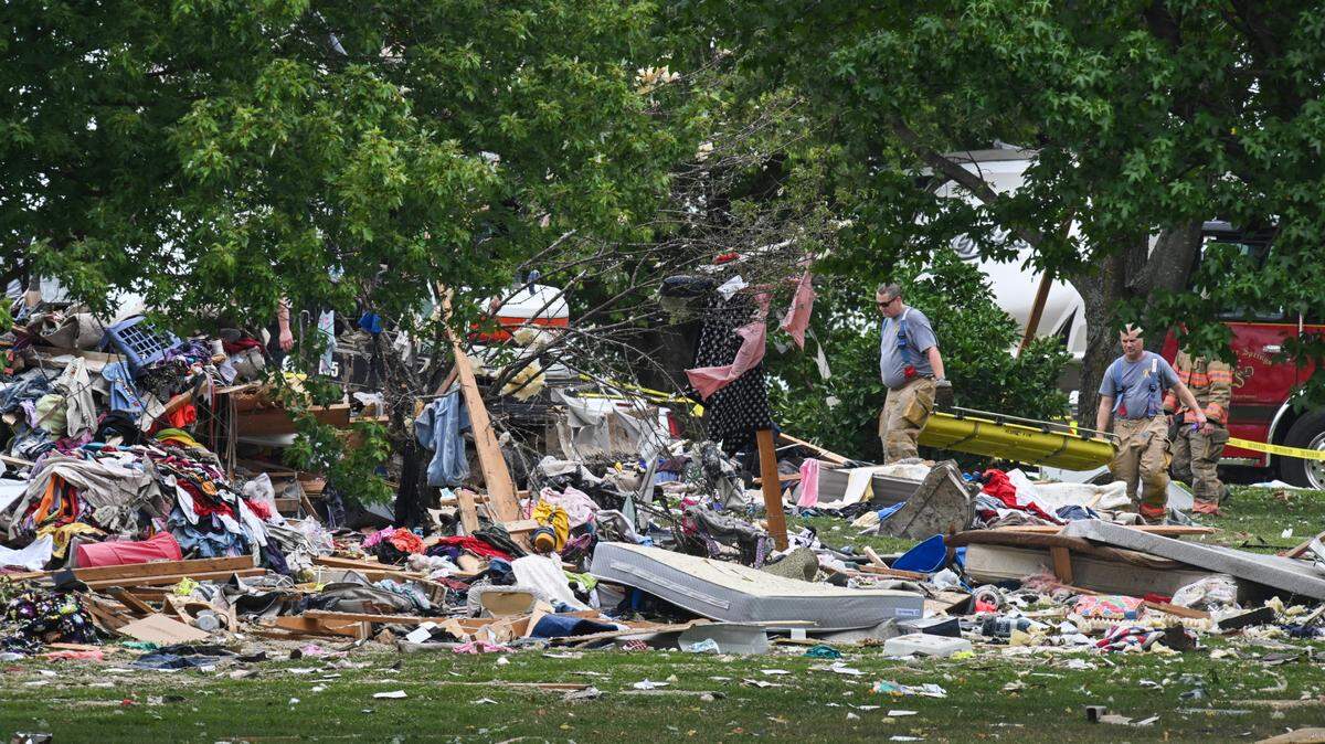 Rescue personell carry a stretcher through debris from a home explosion that happened in the early morning of hours Friday, August 23, 2024, in Excelsior Springs. Neighbors say the blast could be felt and seen for many miles and blew open the doors of neighbors’ houses.