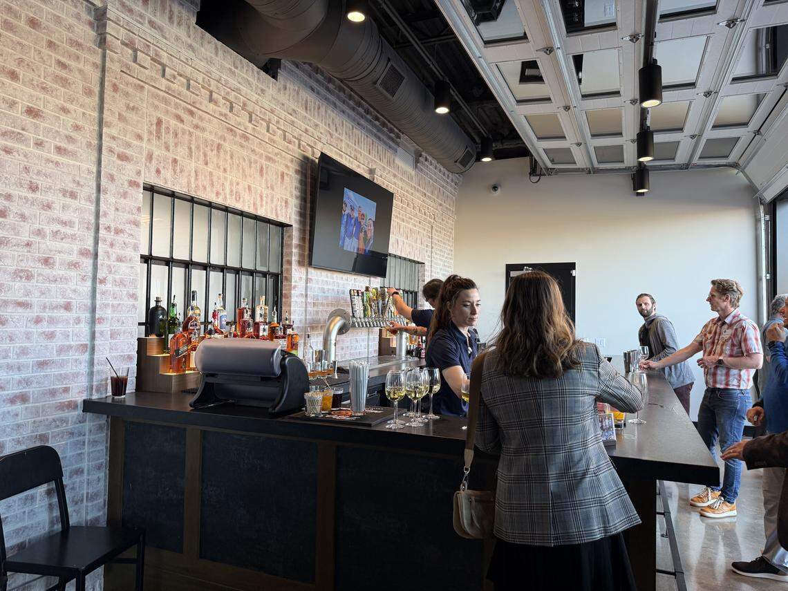 A bar faces the outdoor patio at Q39. Garage-style doors let outside air flow in.