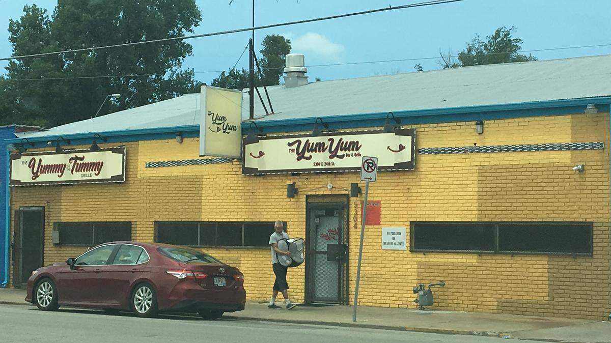 Two security guards with an Overland Park firm were charged with murder in a fatal shooting in June outside the Yum Yum Bar in Kansas City.