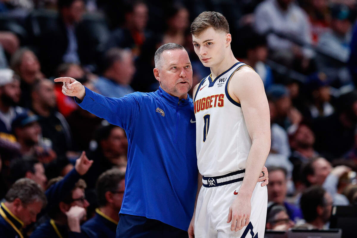Denver Nuggets head coach Michael Malone talks with guard Christian Braun (0) in the fourth quarter against the New Orleans Pelicans at Ball Arena on March 30, 2023.