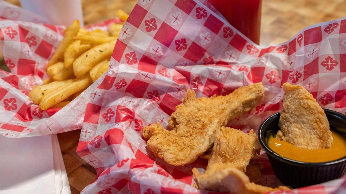 The Savage Saloon menu includes chicken strips with a side barbecue dipping sauce and seasoned french fries.
