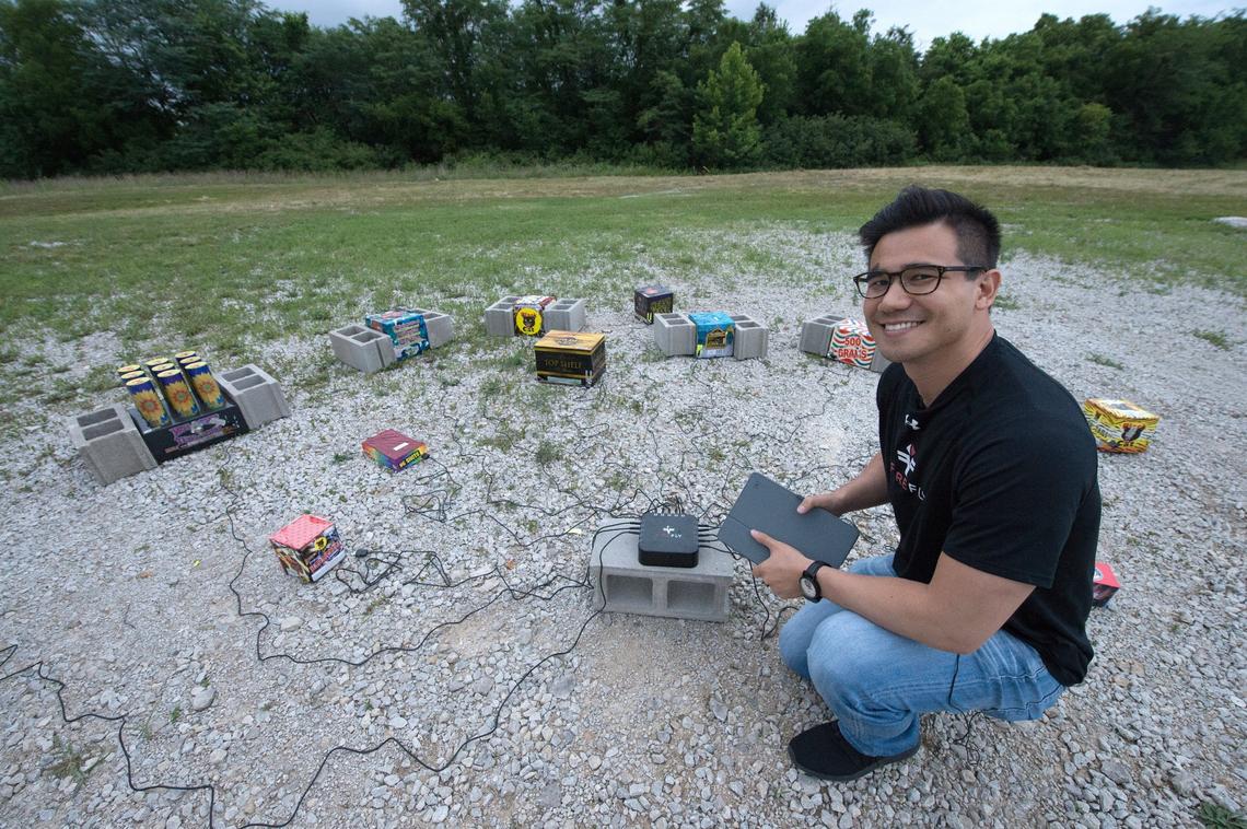 Kevin Wu, 28, product developer for Winco Fireworks, connects a Firefly device with a dozen of fireworks and later he would set off the fireworks from his tablet.