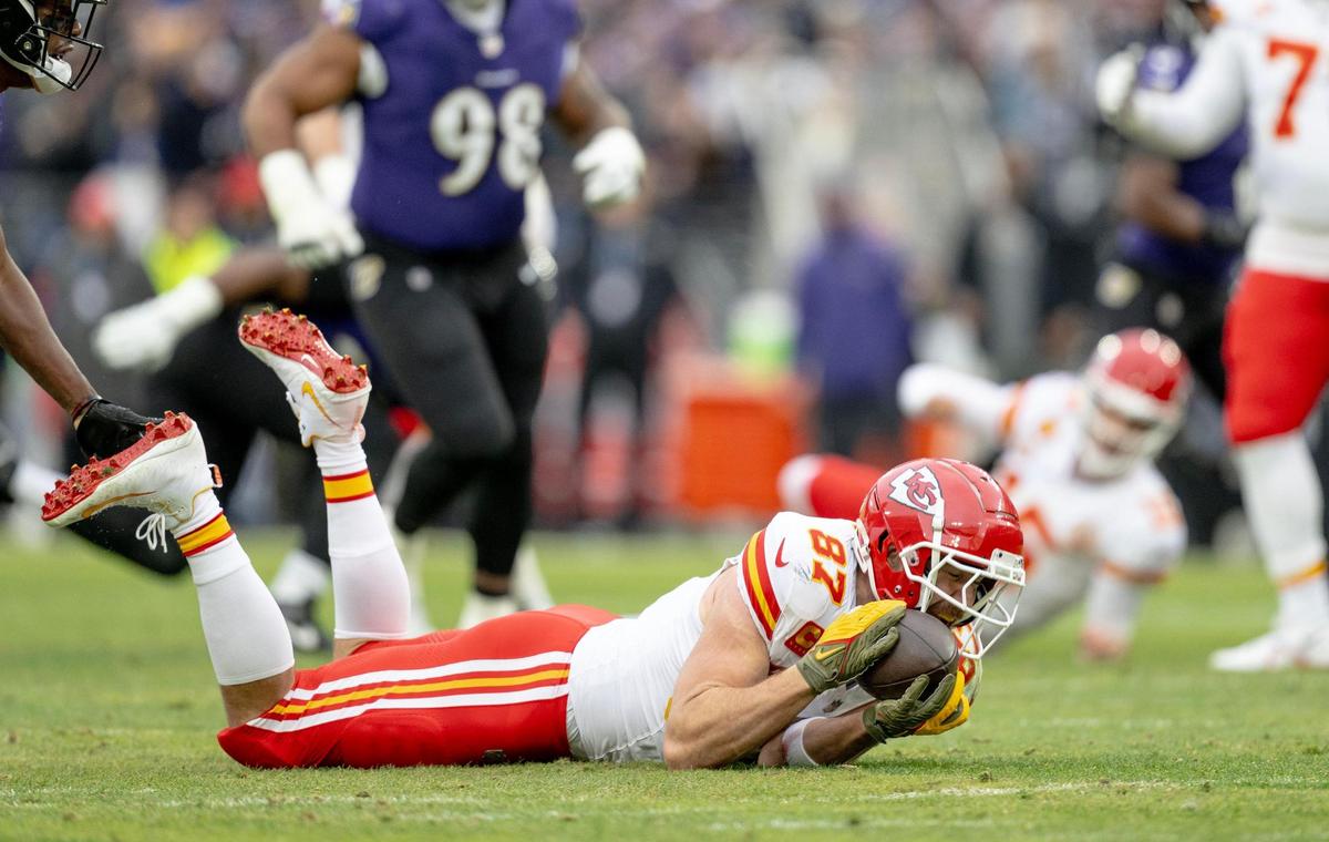 Kansas City Chiefs tight end Travis Kelce (87) secures a catch for a first down against the Baltimore Ravens during the AFC Championship Game on Sunday, Jan. 28, 2024, in Baltimore.