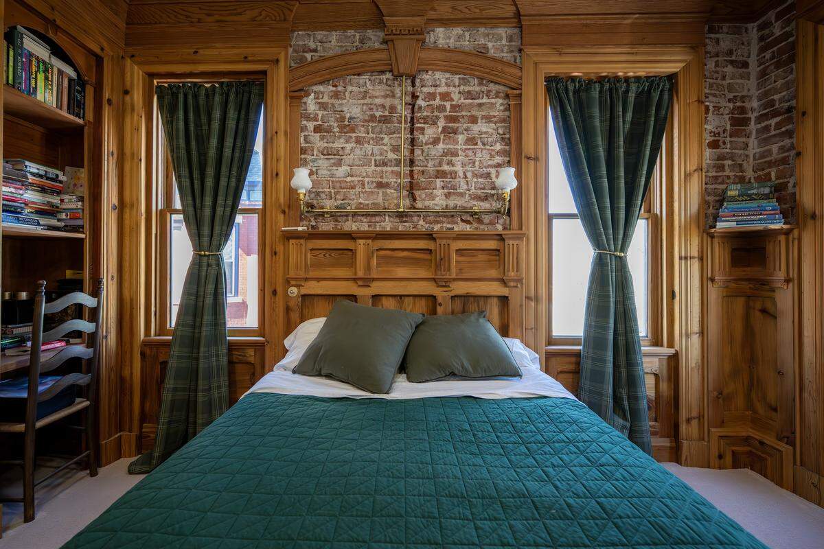 Exposed brick adorns the primary bedroom at the Bezanson family home on Wednesday, April 8, 2026, in Kansas City.