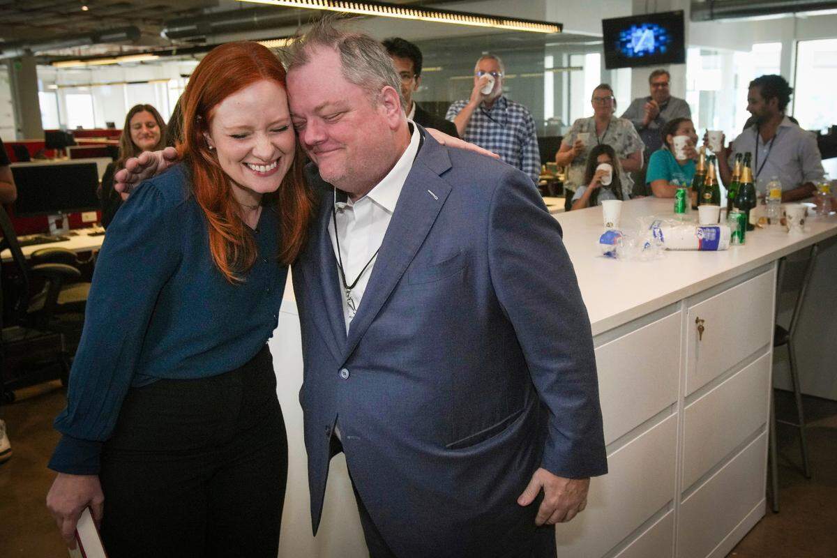 Lisa Falkenberg, editor of opinion for the Houston Chronicle, left, and Michael Lindenberger, deputy opinion editor, embraced as they celebrated winning a Pulitzer Prize for editorial writing on May 9, 2022, in Houston.