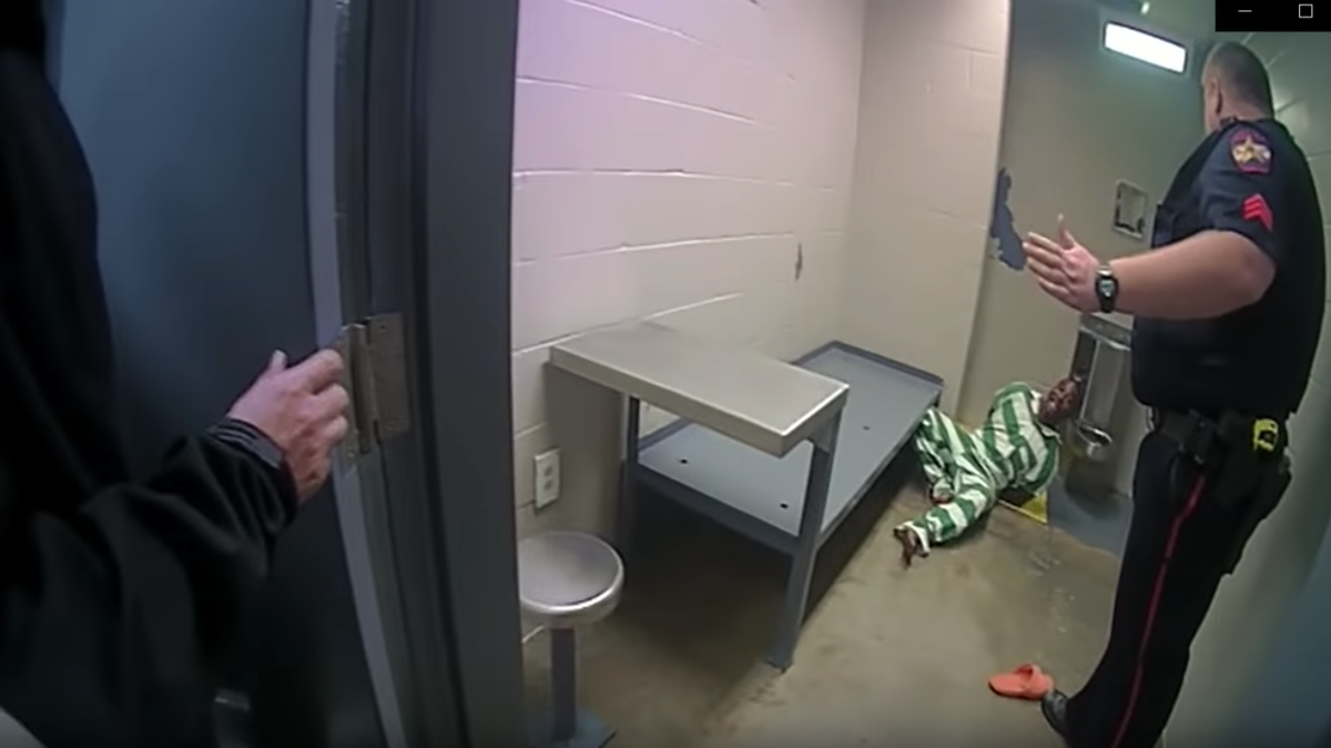 A handcuffed Chester Jackson on the floor after what guard calls a “fall.”