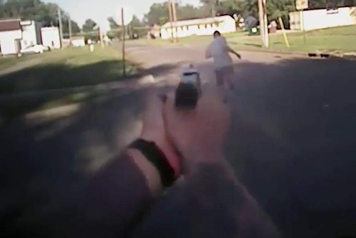 Police body cam footage shows Dominique White fleeing as he was shot and killed.